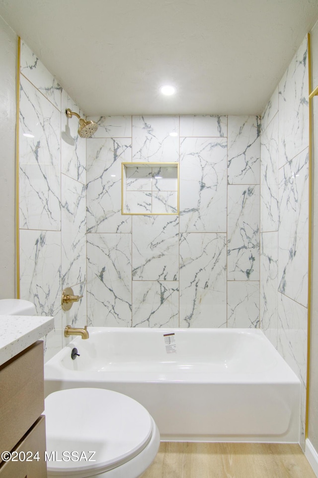 bathroom featuring shower / tub combination, wood finished floors, toilet, and vanity