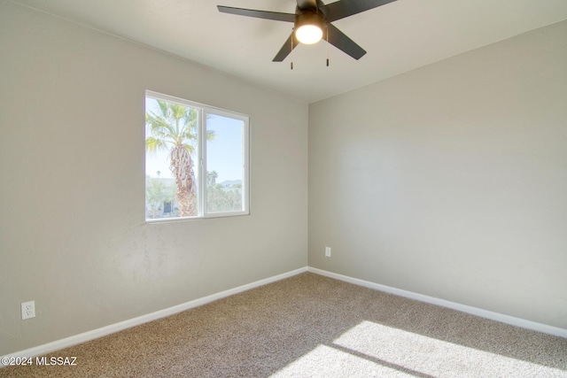 carpeted empty room with baseboards and ceiling fan