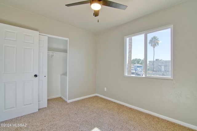 unfurnished bedroom with carpet, a closet, ceiling fan, and baseboards