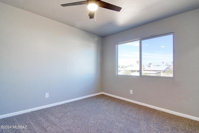 unfurnished room with baseboards, carpet floors, and a ceiling fan
