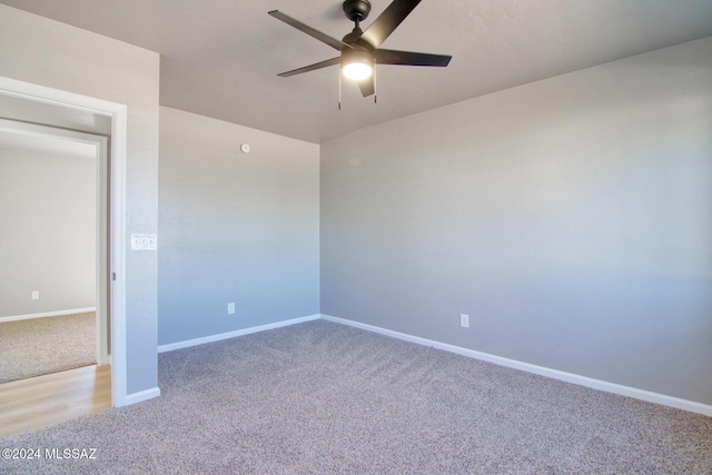 empty room featuring baseboards, ceiling fan, and light colored carpet