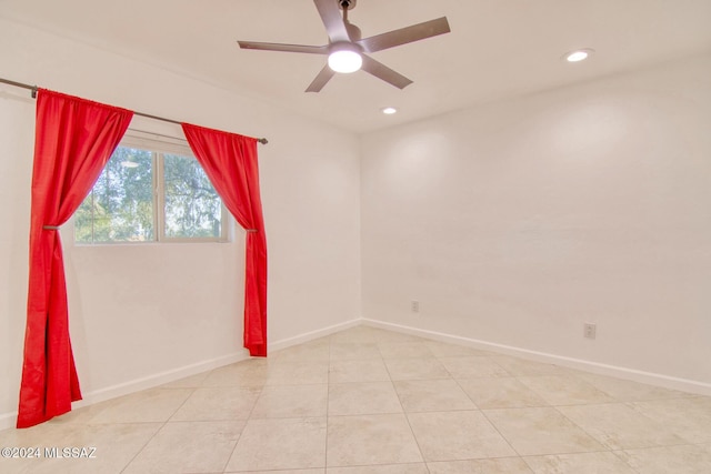 empty room featuring light tile patterned floors, baseboards, a ceiling fan, and recessed lighting