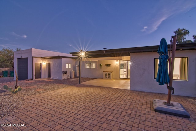 back of house featuring a patio and stucco siding
