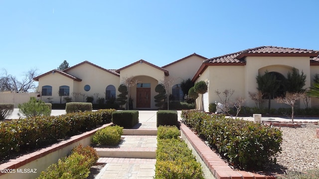 1445 W Fairway Dr, Nogales, AZ 85621 - mediterranean / spanish-style house with a tile roof, stucco siding, and an attached garage
