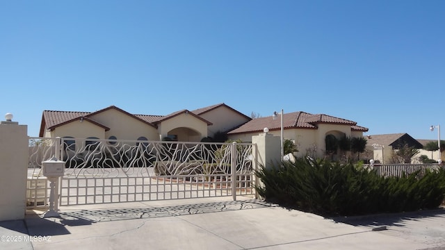 1445 W Fairway Dr, Nogales, AZ 85621 - mediterranean / spanish-style house with a tile roof, a gate, stucco siding, and fence