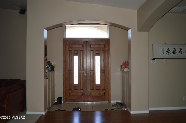 1445 W Fairway Dr, Nogales, AZ 85621 - entrance foyer featuring baseboards, wood finished floors, and arched walkways