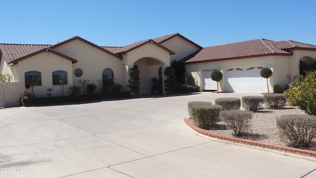 1445 W Fairway Dr, Nogales, AZ 85621 - mediterranean / spanish-style home with a tile roof, driveway, a garage, and stucco siding