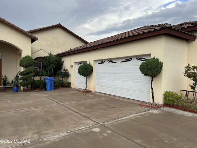 1445 W Fairway Dr, Nogales, AZ 85621 - view of side of home featuring stucco siding, a tile roof, a garage, and concrete driveway