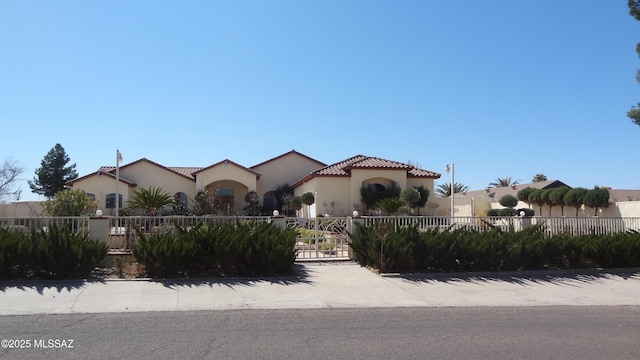 1445 W Fairway Dr, Nogales, AZ 85621 - mediterranean / spanish-style home featuring a tiled roof, stucco siding, a gate, and a fenced front yard