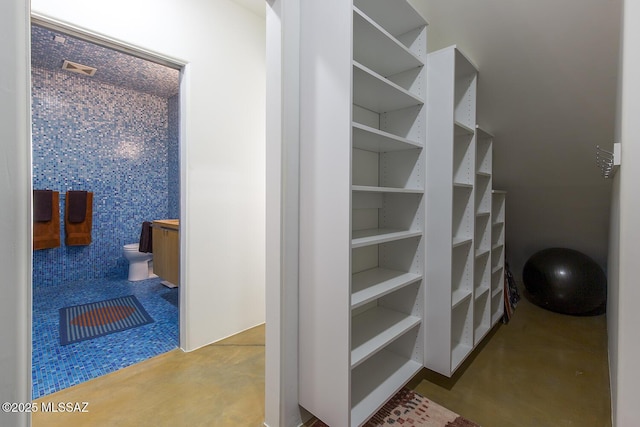 stairs featuring finished concrete flooring