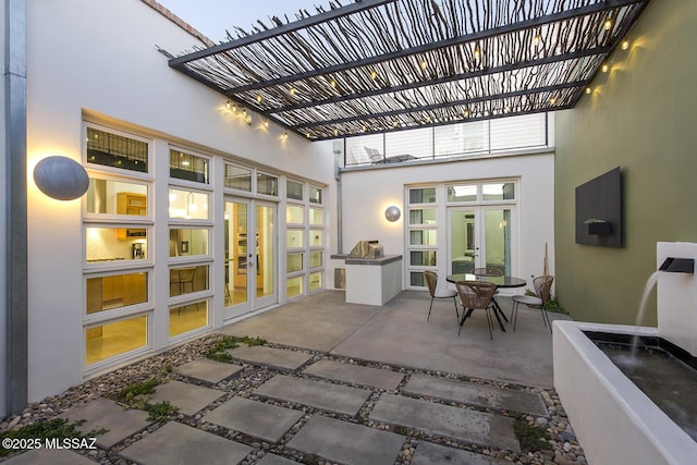view of patio featuring french doors and a pergola