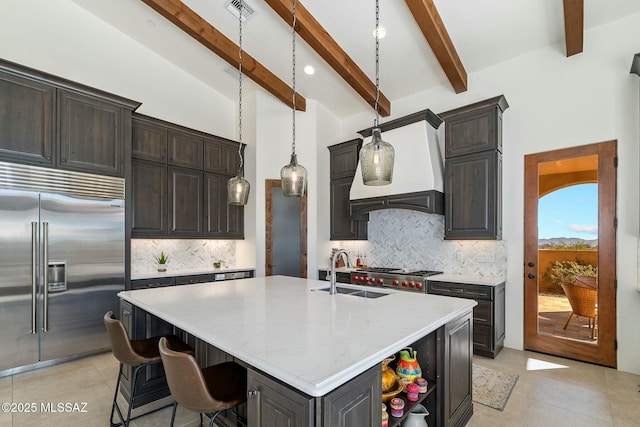 14623 N Shaded Stone Pl, Oro Valley, AZ 85755 - kitchen with light tile patterned floors, visible vents, custom exhaust hood, a sink, and built in fridge