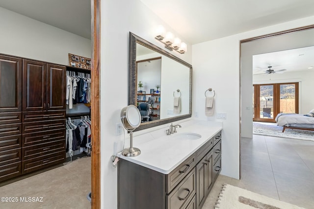 14623 N Shaded Stone Pl, Oro Valley, AZ 85755 - bathroom with vanity, tile patterned flooring, ensuite bath, a ceiling fan, and a walk in closet