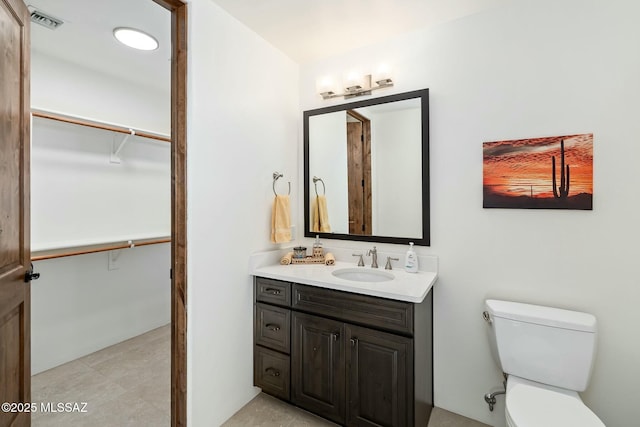 14623 N Shaded Stone Pl, Oro Valley, AZ 85755 - bathroom with toilet, vanity, a spacious closet, and visible vents