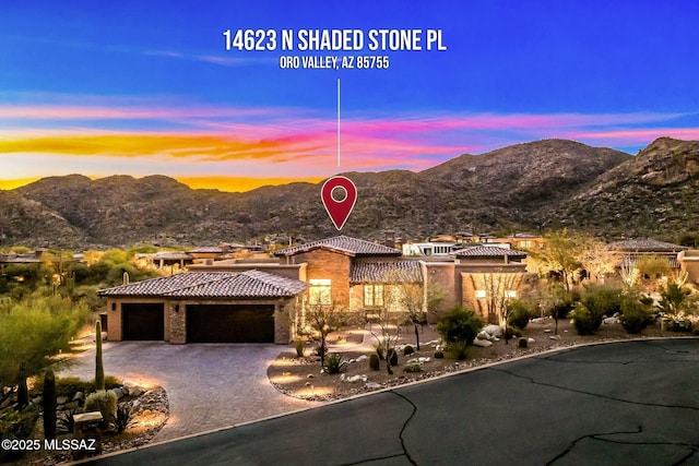 14623 N Shaded Stone Pl, Oro Valley, AZ 85755 - view of front of home featuring a tiled roof, a mountain view, an attached garage, and decorative driveway