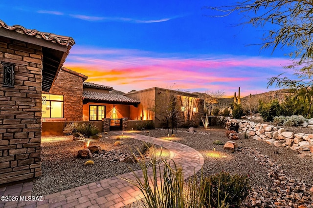14623 N Shaded Stone Pl, Oro Valley, AZ 85755 - back of property at dusk with a tile roof