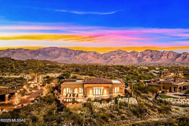 14623 N Shaded Stone Pl, Oro Valley, AZ 85755 - back of property at dusk featuring stucco siding, a mountain view, and a tile roof