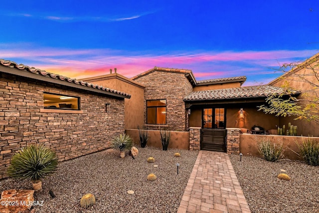 14623 N Shaded Stone Pl, Oro Valley, AZ 85755 - mediterranean / spanish house with stucco siding, stone siding, and a tile roof