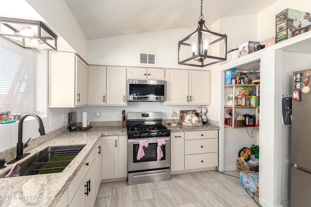 kitchen with a chandelier, a sink, visible vents, white cabinets, and appliances with stainless steel finishes