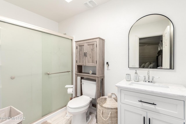 full bathroom featuring toilet, vanity, a shower stall, and visible vents