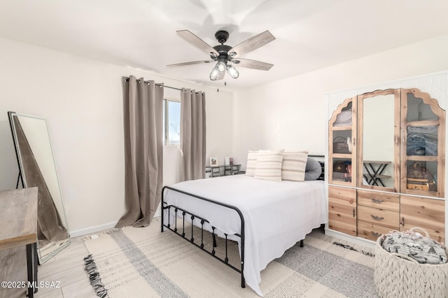 bedroom featuring baseboards and ceiling fan
