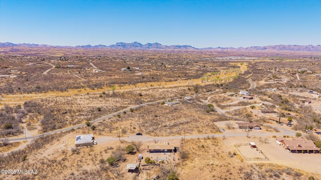 birds eye view of property with a mountain view and a desert view