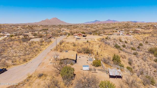birds eye view of property with a mountain view and view of desert