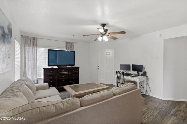 living room with baseboards, ceiling fan, and wood finished floors