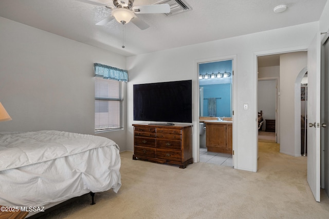 4654 W Gatehinge Ct, Tucson, AZ 85741 - bedroom featuring arched walkways, light carpet, a sink, connected bathroom, and a ceiling fan