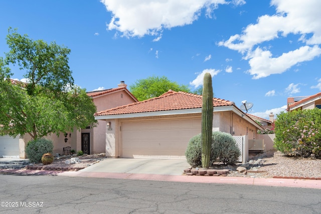 4654 W Gatehinge Ct, Tucson, AZ 85741 - mediterranean / spanish house with an attached garage, stucco siding, driveway, and a tiled roof