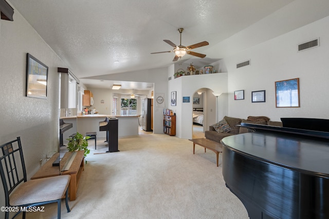 4654 W Gatehinge Ct, Tucson, AZ 85741 - living room with ceiling fan, light colored carpet, arched walkways, lofted ceiling, and visible vents