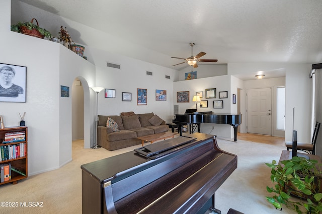 4654 W Gatehinge Ct, Tucson, AZ 85741 - living area with visible vents, lofted ceiling, light carpet, ceiling fan, and arched walkways