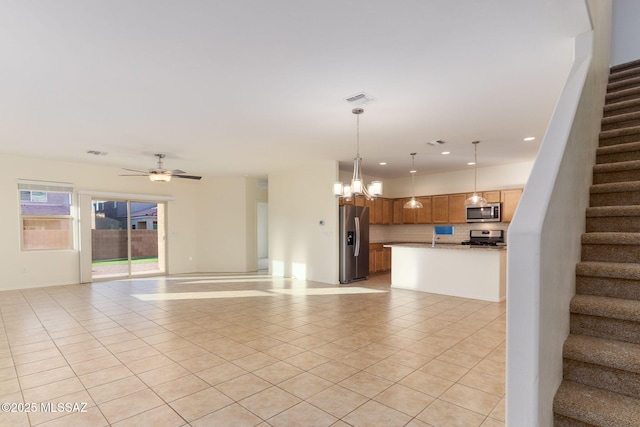 6866 E Via Arroyo Largo, Tucson, AZ 85756 - unfurnished living room featuring stairway, light tile patterned floors, recessed lighting, ceiling fan, and a chandelier