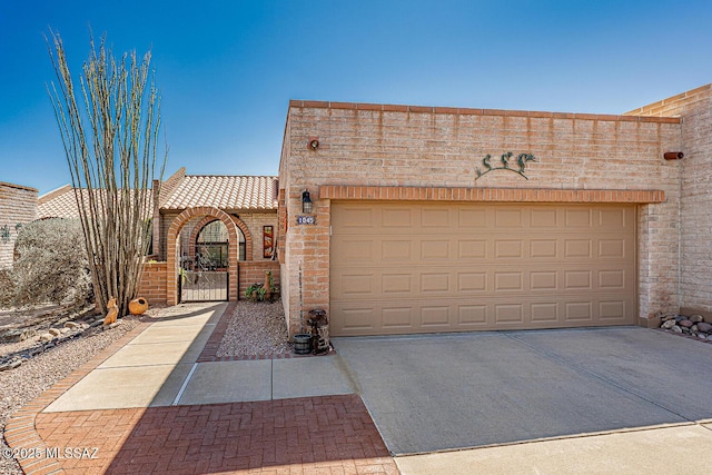 exterior space with driveway and a gate