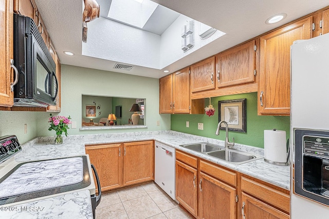 kitchen with refrigerator with ice dispenser, electric range, a sink, visible vents, and white dishwasher