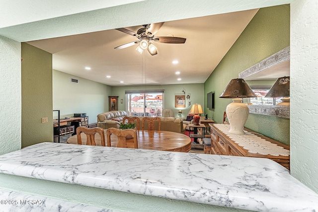 dining room with a ceiling fan, recessed lighting, a textured wall, and visible vents