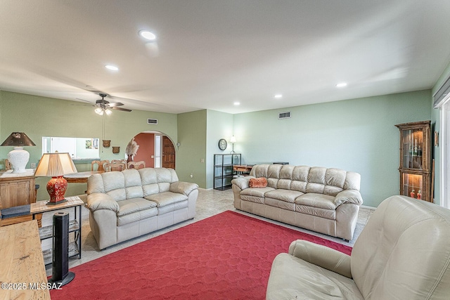 living room with visible vents, arched walkways, ceiling fan, and recessed lighting