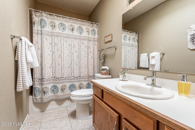 bathroom with toilet, tile patterned flooring, and vanity
