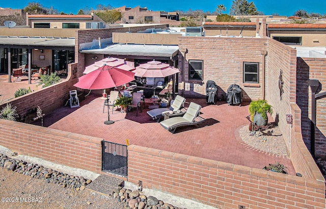 exterior space with outdoor dining space, a patio area, and fence private yard