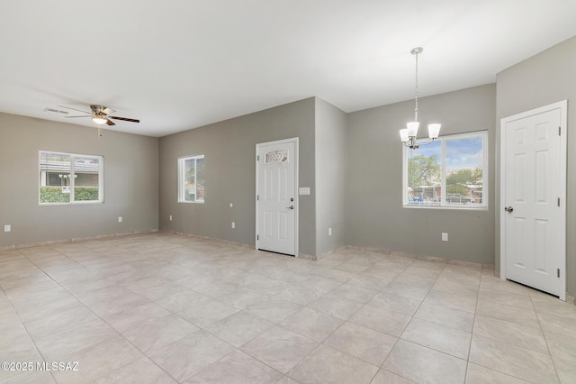 9121 W Claude St, Tucson, AZ 85735 - unfurnished room featuring a wealth of natural light, visible vents, and ceiling fan with notable chandelier