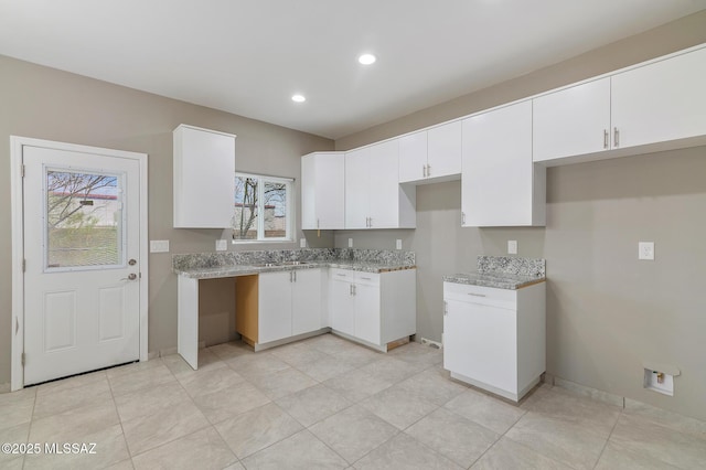 9121 W Claude St, Tucson, AZ 85735 - kitchen with white cabinets, recessed lighting, light stone countertops, and baseboards