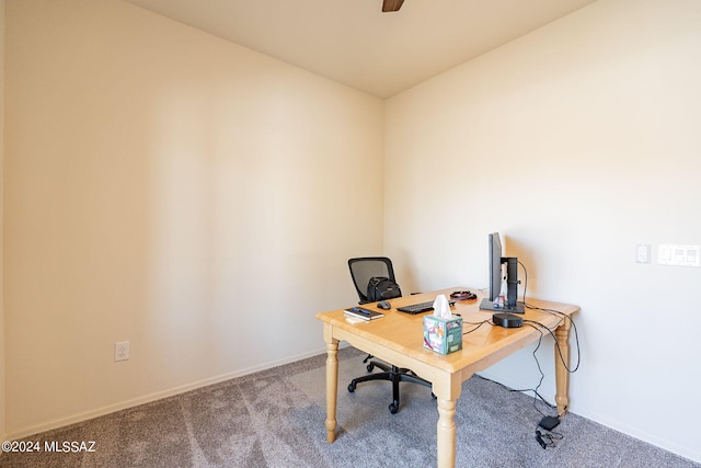 carpeted office space with baseboards and ceiling fan