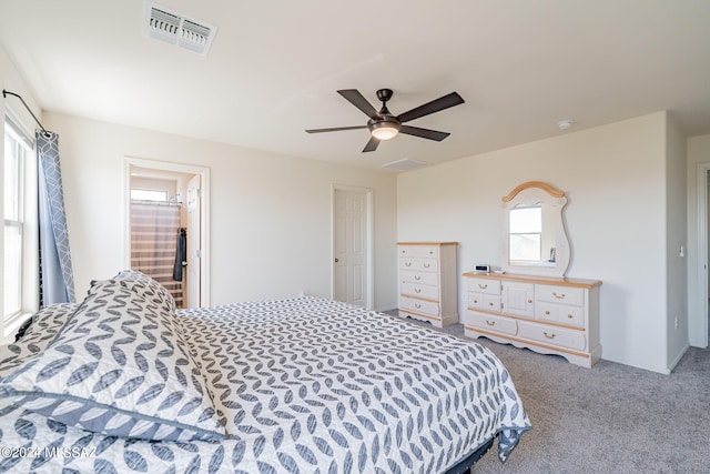 carpeted bedroom with visible vents and a ceiling fan