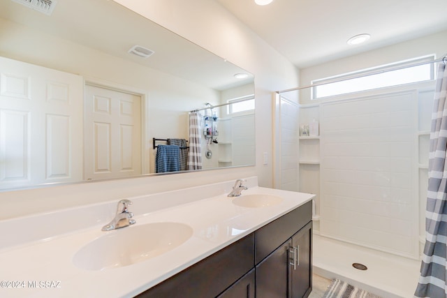bathroom featuring a sink, a stall shower, and visible vents