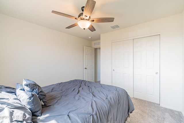 bedroom featuring light carpet, a closet, ceiling fan, and visible vents