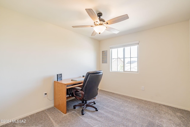 home office featuring baseboards, ceiling fan, and carpet