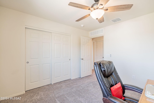 office space with a ceiling fan, carpet floors, baseboards, and visible vents