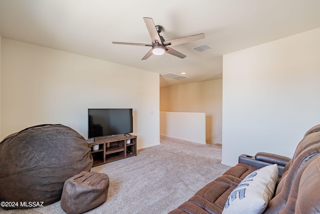 living area with carpet flooring, ceiling fan, and visible vents