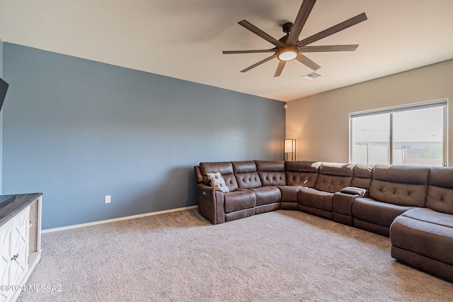 living area featuring carpet floors, baseboards, ceiling fan, and visible vents