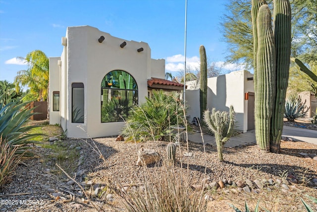 view of side of property with stucco siding